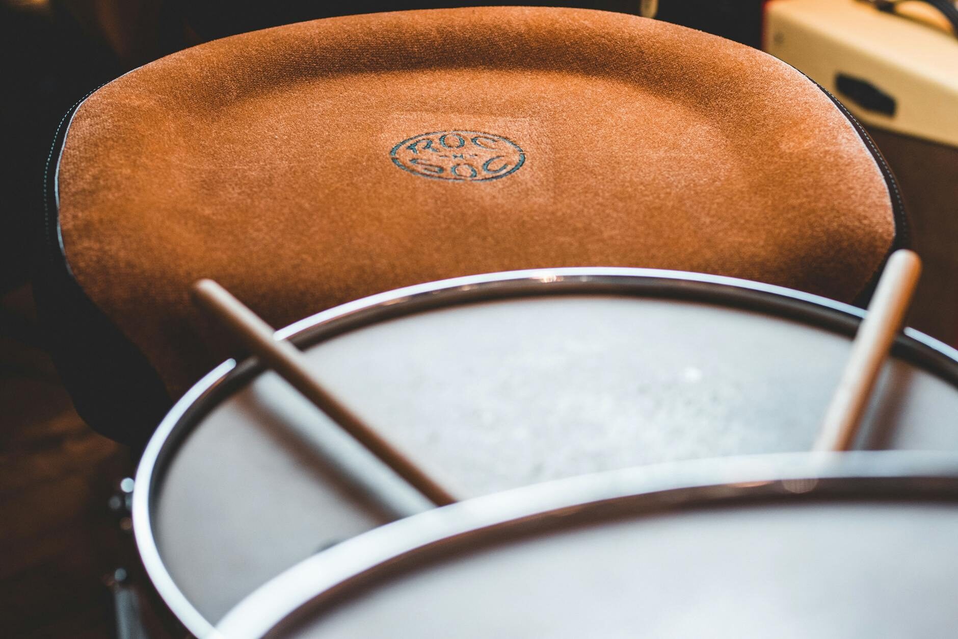 Timpani drum head close-up with mallets in warm light